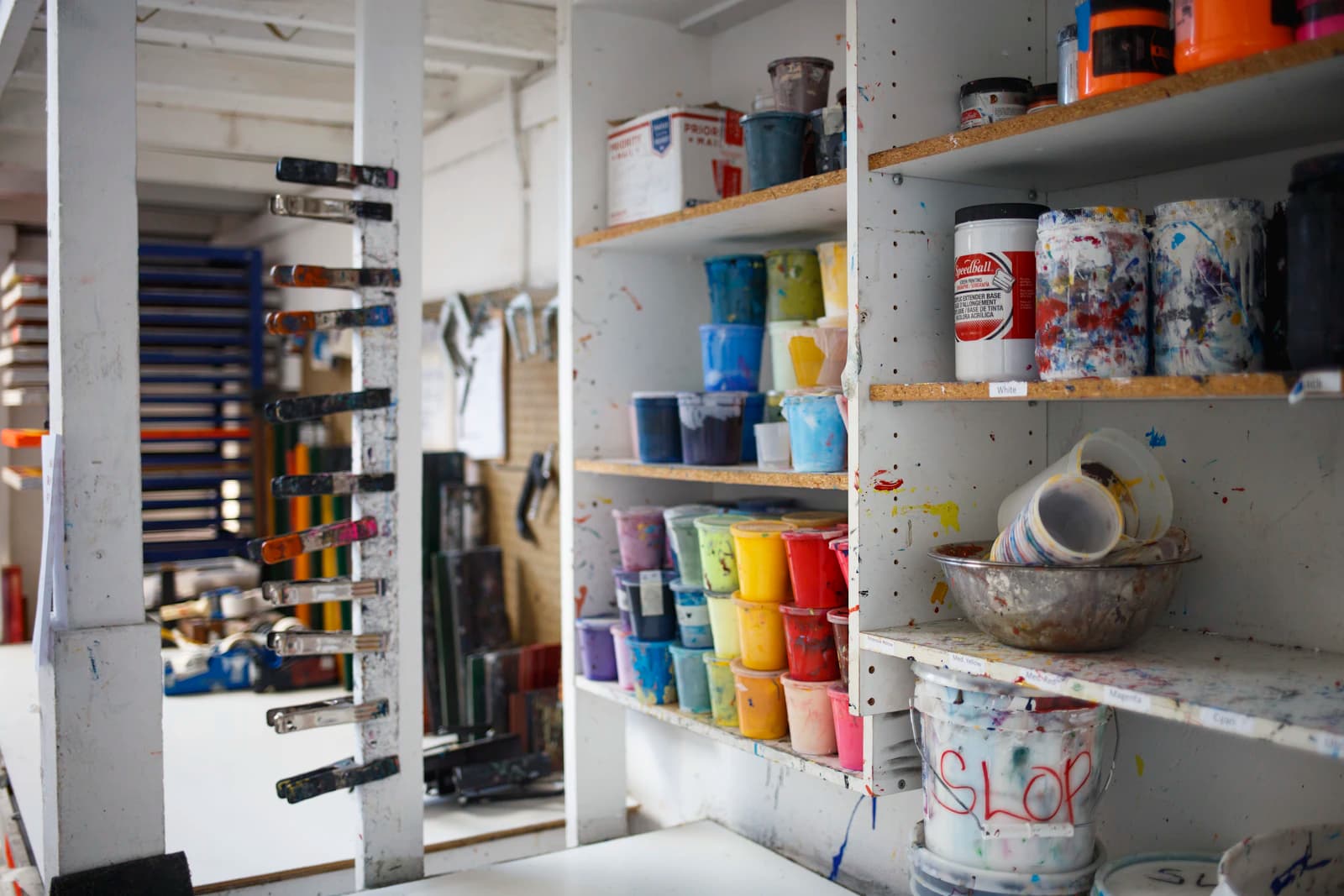 Person taking a photo of paint containers on a display rack